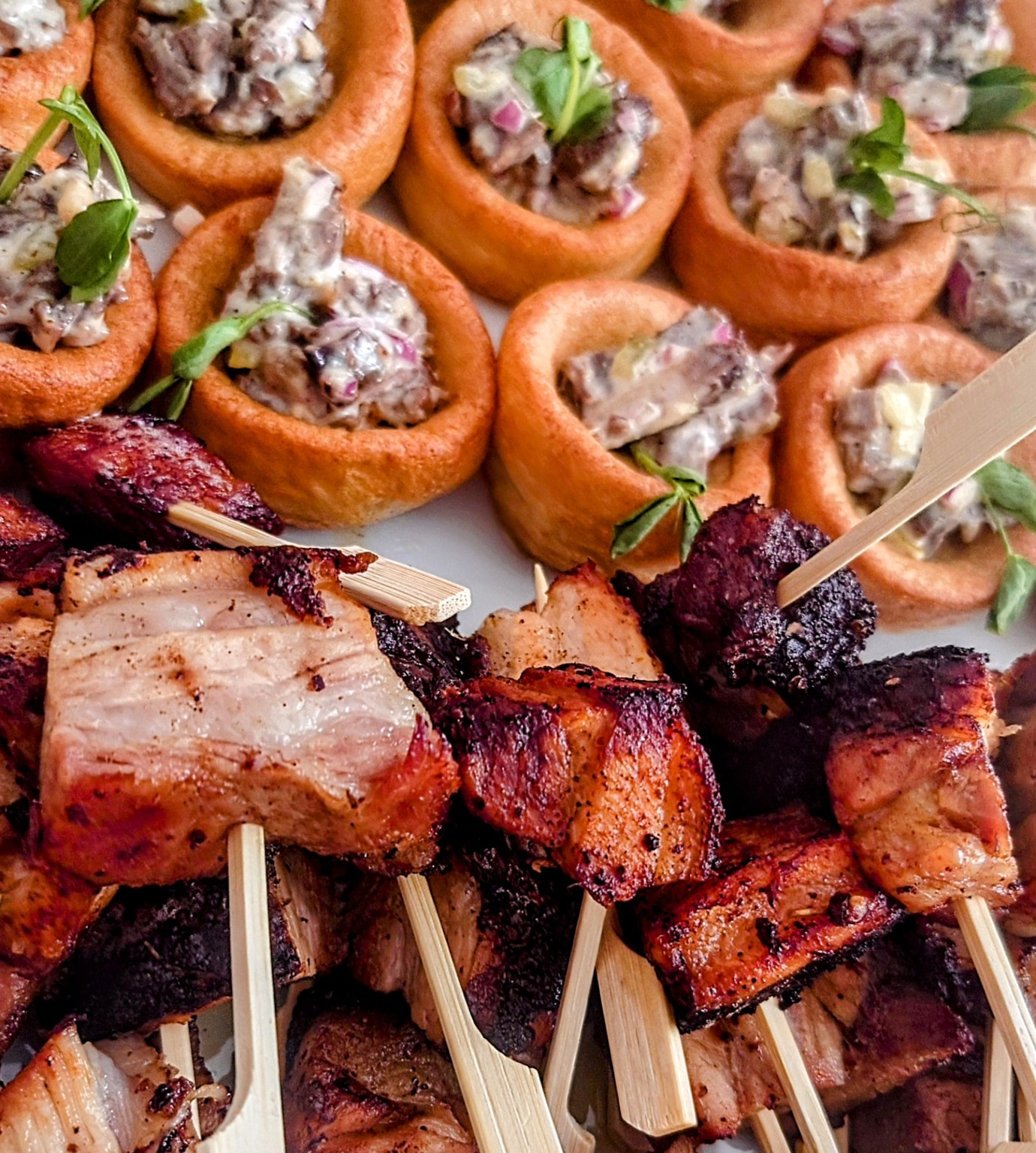 Golden filled Yorkshire pudding bites and grilled meat skewers