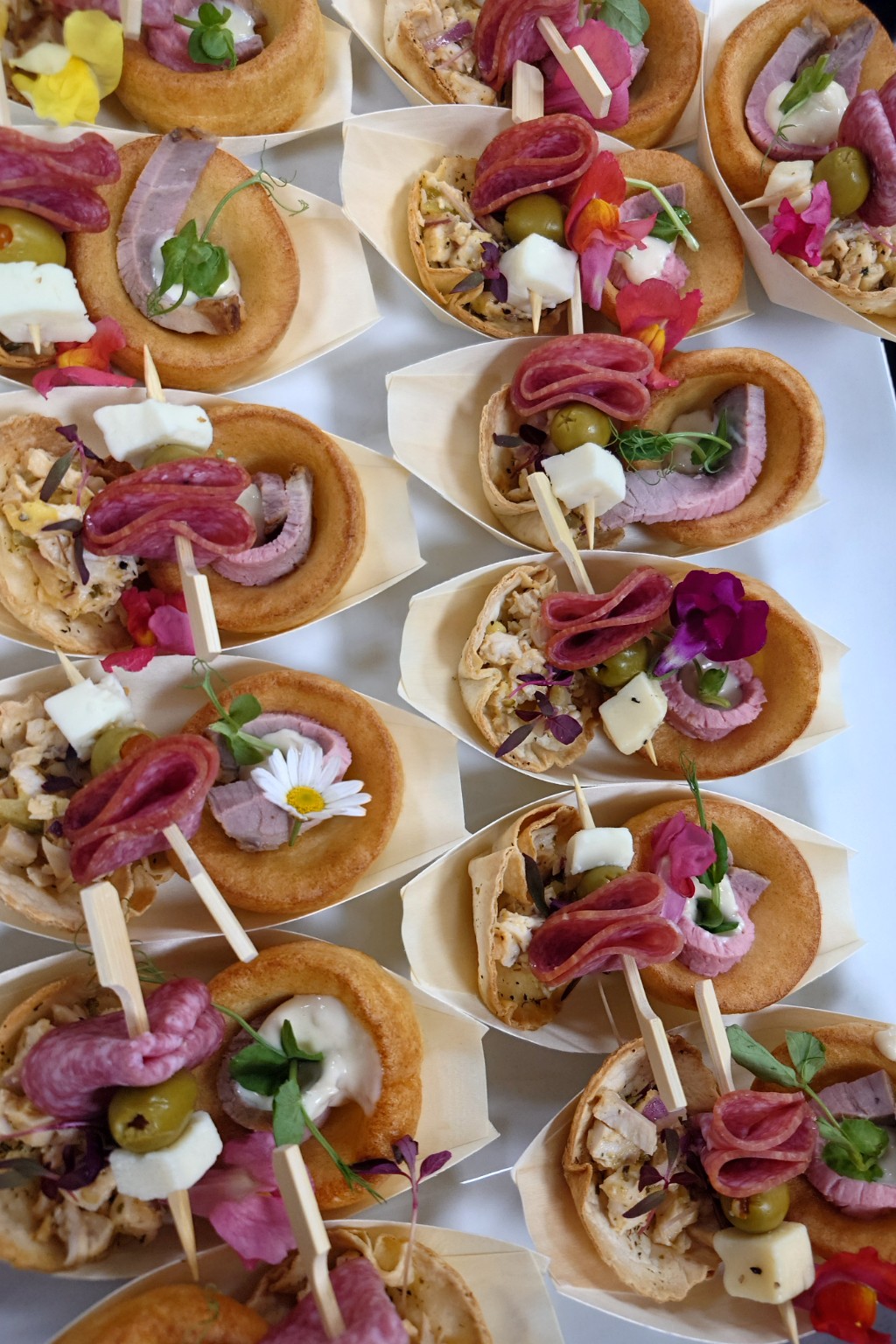 Individual savoury platters with filled Yorkshire puddings, tartlets and antipasti skewers