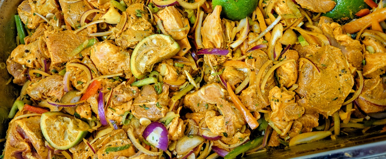 A generously filled tray with lime, sliced vegetables and spiced meat